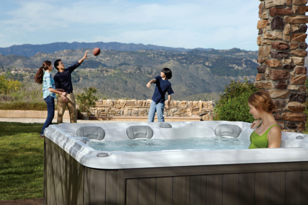 Protecting Your Hot Tub with a family playing football in the background