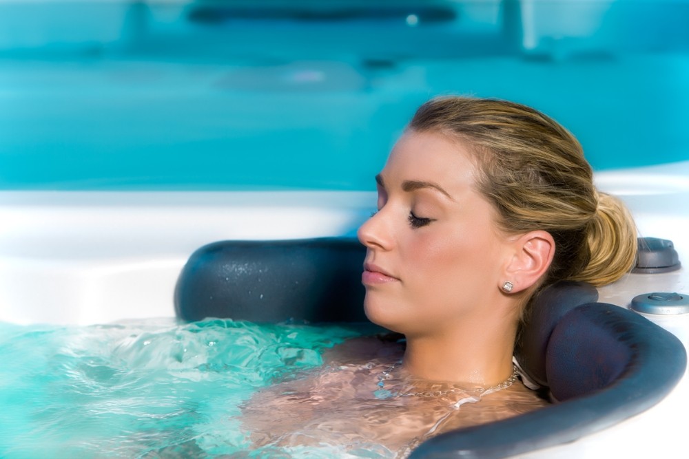 Woman relaxing in Hydropool Swim Spa - The Hydropool Dealers at Great Bay Spa & Sauna serving New England explain the stress-relieving benefits of hydrotherapy.