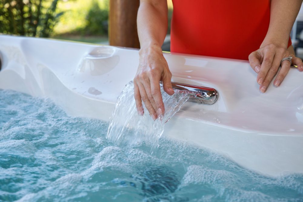 Woman with a Sundance® Spa - The hot tub experts at Great Bay Spa & Sauna explain the pros and cons of chlorine and bromine.