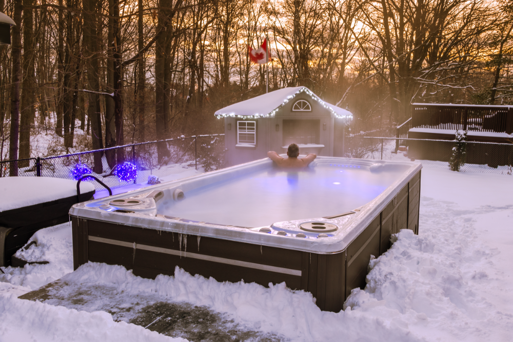 Man soaking in a Hydropool swim spa in the winter - Great Bay Spa & Sauna explains what makes a Hydropool different