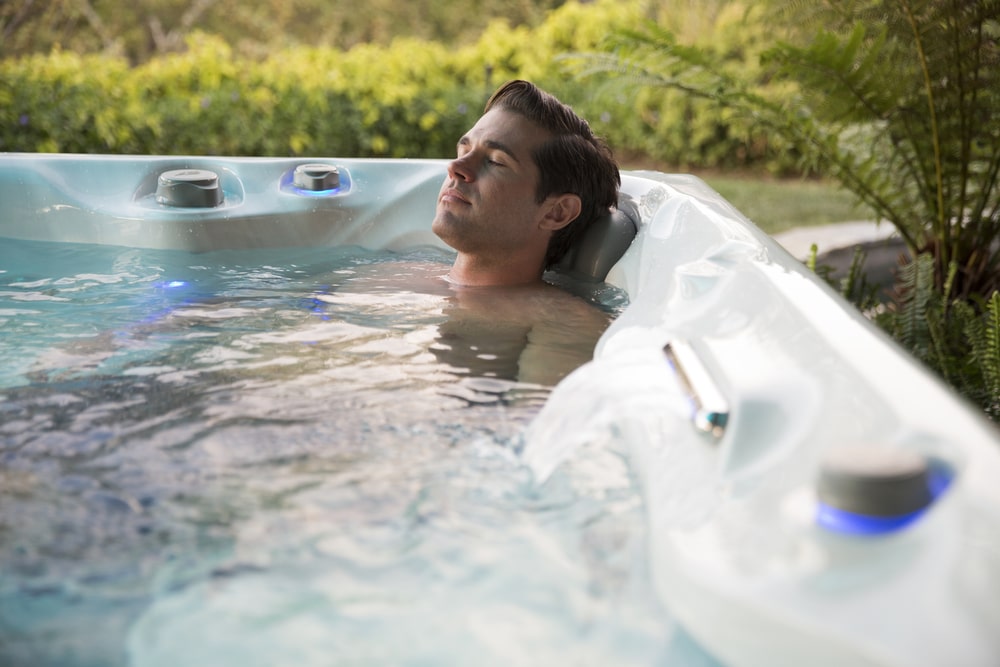 man relaxing in hot tub