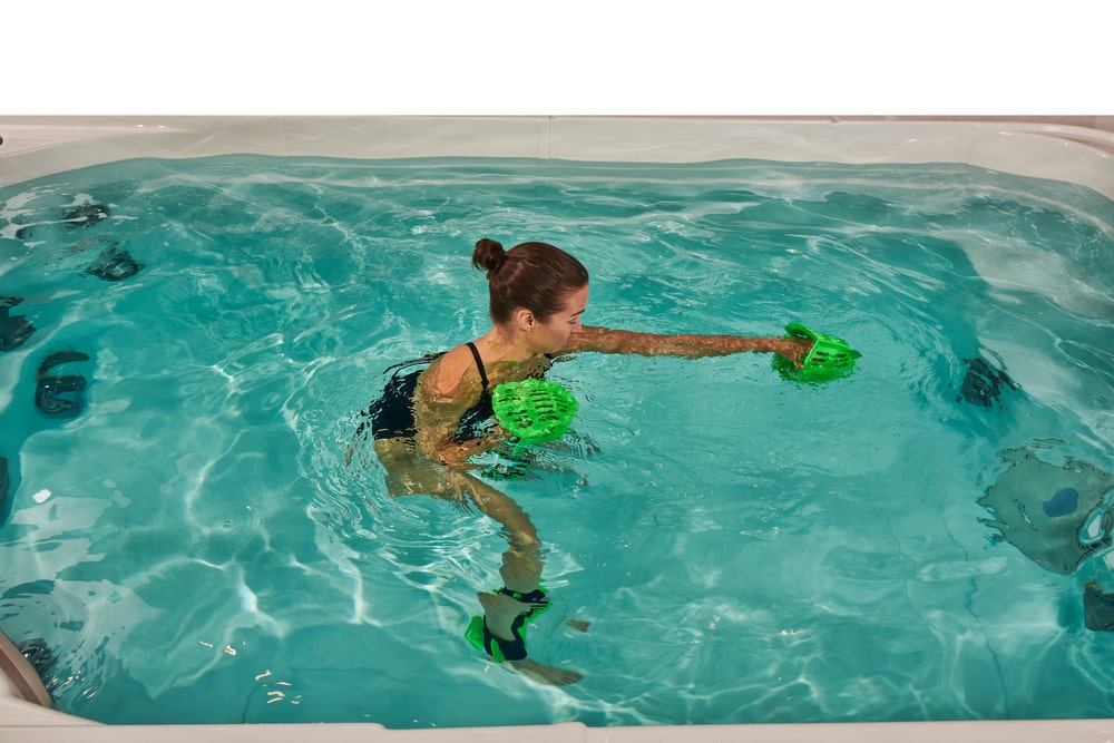 woman is exercising in swim spa using box fit