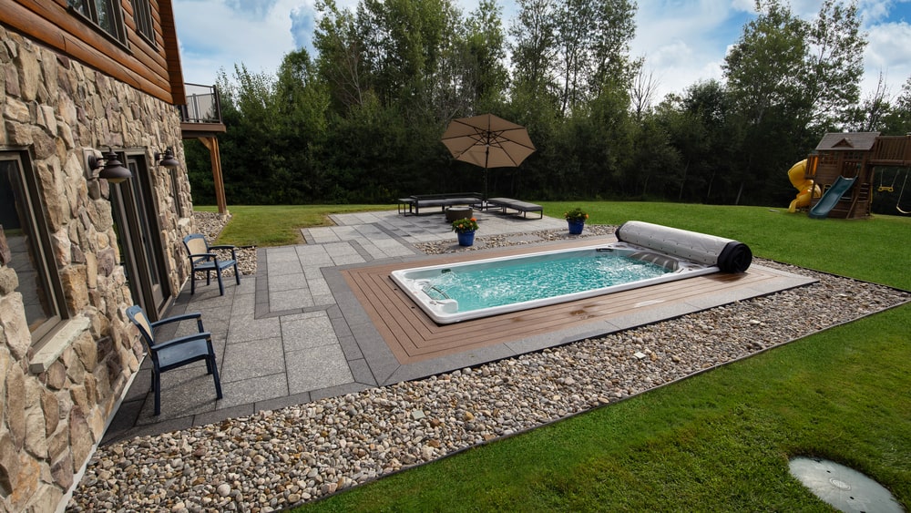 swimming spa installed in a backyard of a countryside home