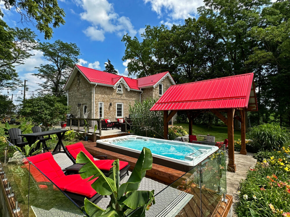 A Hydropool swim spa behind a home.